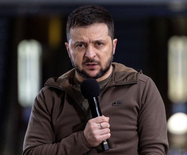 volodymyr zelenskyy speaks into a microphone