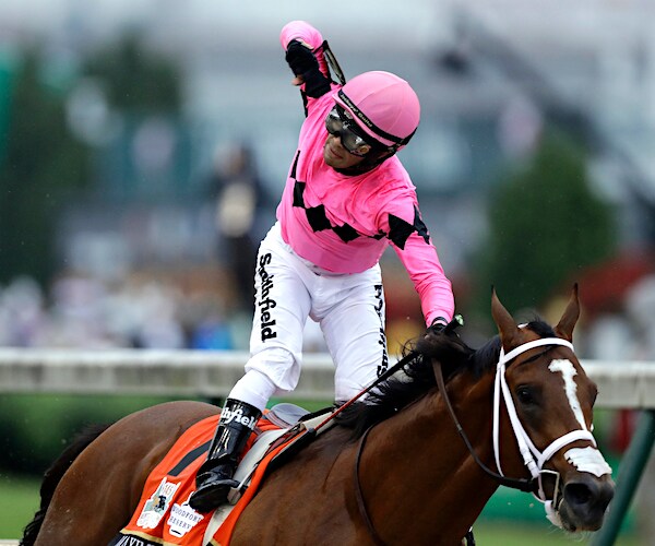 a jockey pumps his first after a big victory at churchill downs in louisville, kentucky