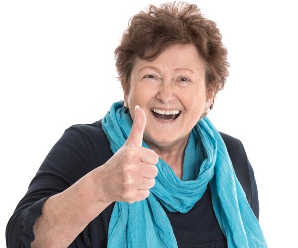 older woman smiling with her thumb up