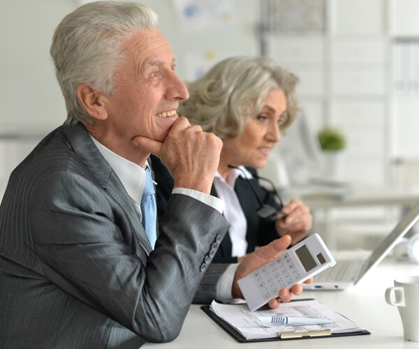 team of older businessmen and businesswomen working in the office 