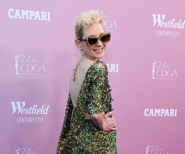anne heche poses on the red carpet