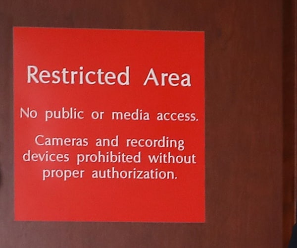a restricted area sign in a congressional hearing room