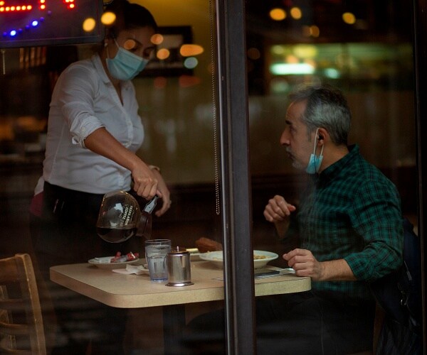 man sits inside restaurant