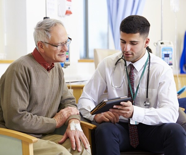 man sitting with doctor