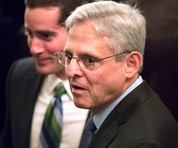 merrick garland looks over his left shoulder after congressional testimony