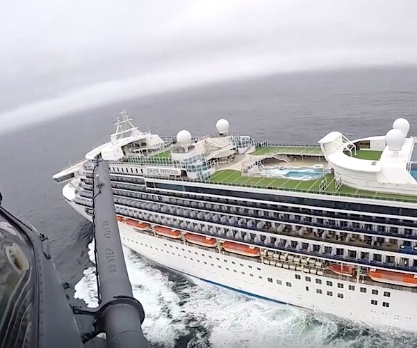A helicopter flies over the Grand Princess cruise ship off the coast of California