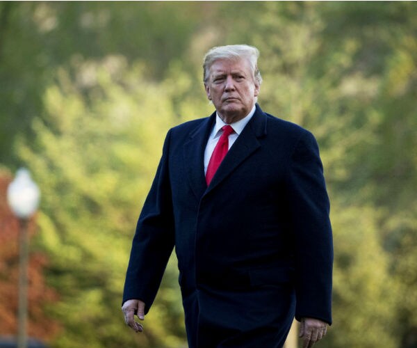 us president donald trump walking on the south lawn of the white house