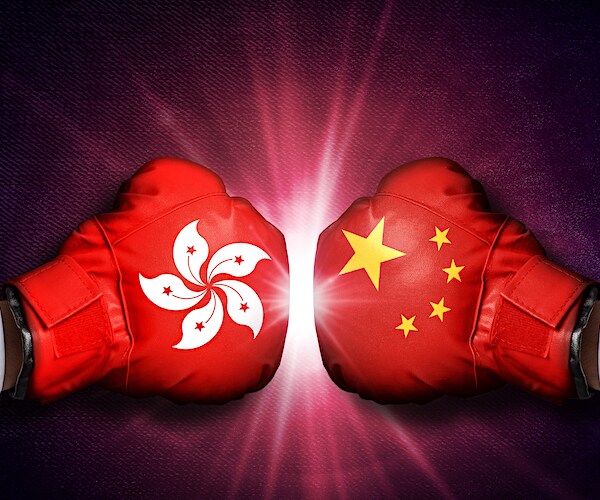 two boxing gloves with the hong kong and china flags on them colliding.