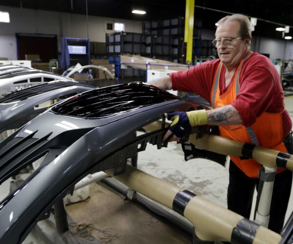 clifford goff,  a bezel assembler, transfers a front end of a general motors chevrolet cruze during assembly in ohio