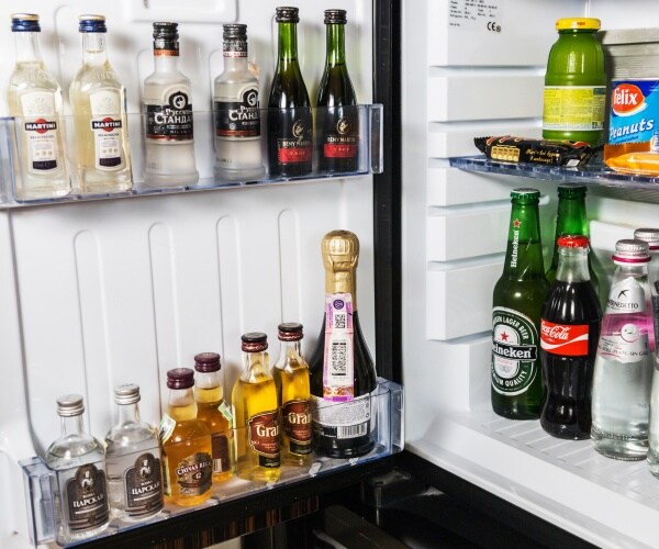 mini fridge with alcoholic drinks soft drinks and some snacks