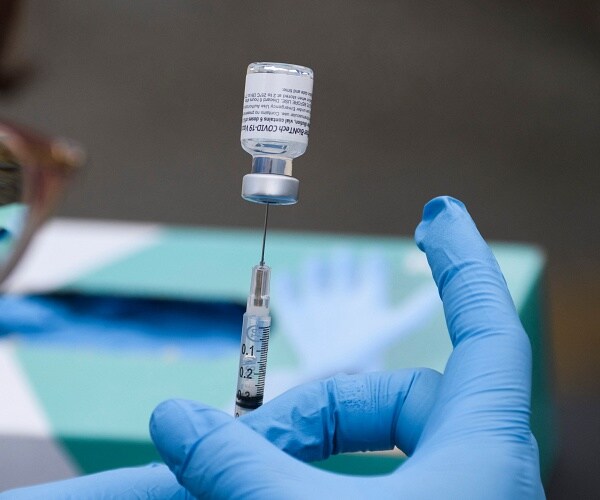 nurse prepares vaccine