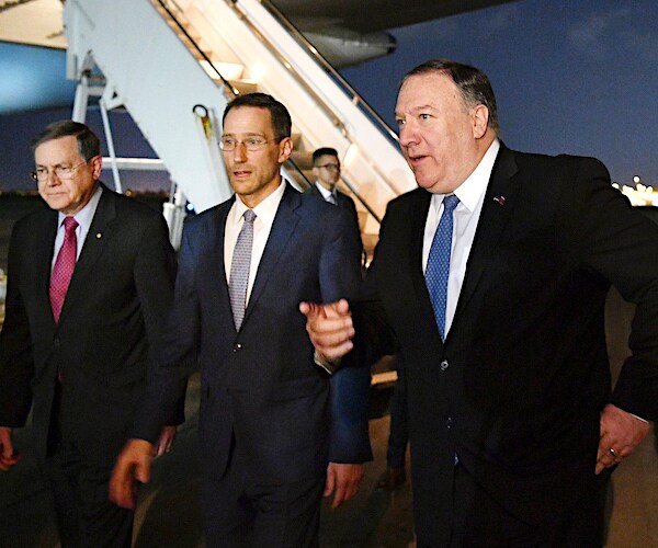Secretary of State Mike Pompeo walks with two other man upon arrival in baghdad