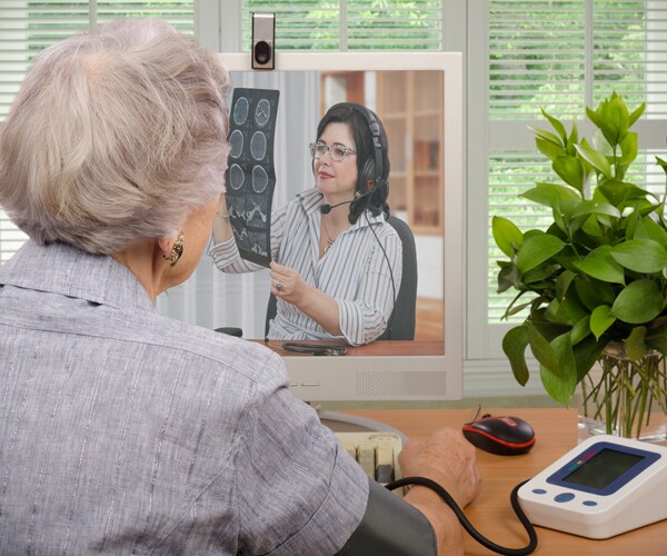A patient talks with her doctor via a video chat