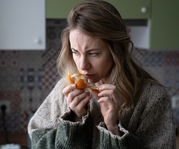 sick woman can't smell a tangerine