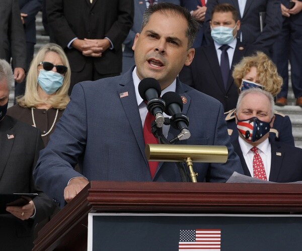 mike garcia speaks into microphone