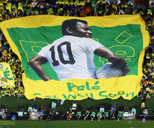 Brazil fans hold a Pele banner