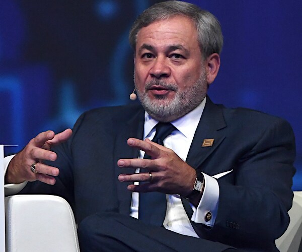 Energy Secretary Dan Brouilette speaks on stage while seated on a couch during a convention