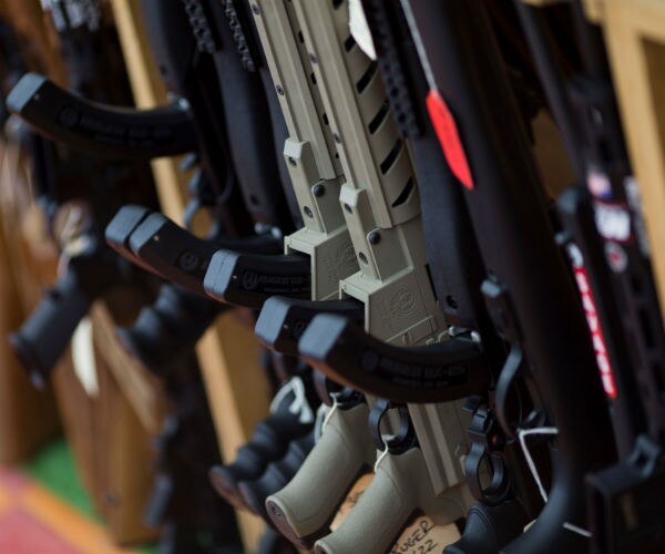 a row of assault-style rifles for sale