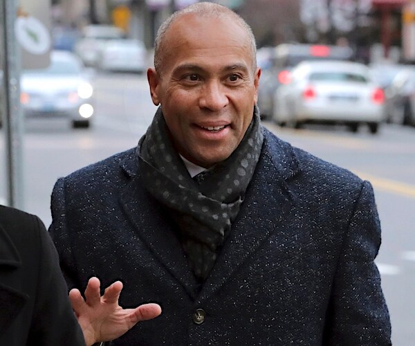 deval patrick gestures while he speaks outside a cafe in new hampshire