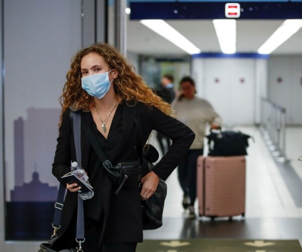 Travelers arrive at the international terminal of the O'Hare Airport in Chicago.