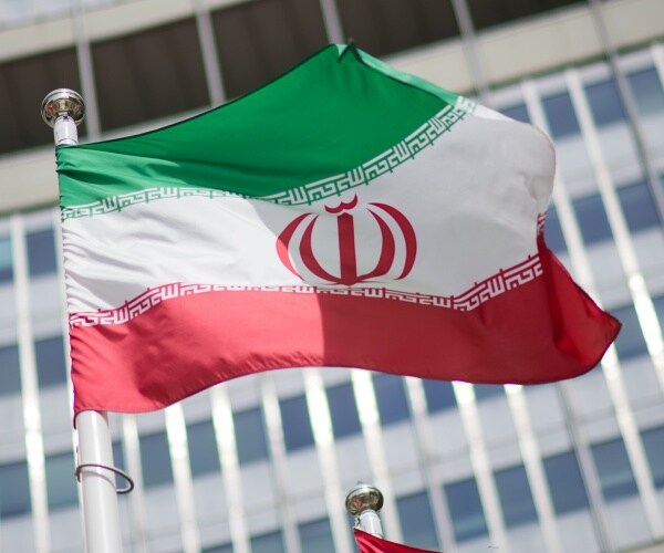The flag of Iran is seen in front of the building of the International Atomic Energy Agency (IAEA) Headquarters.