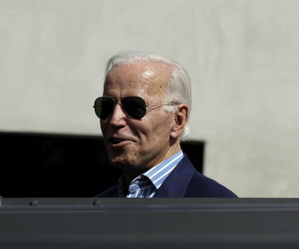 joe biden is shown peeking from an suv rooftop