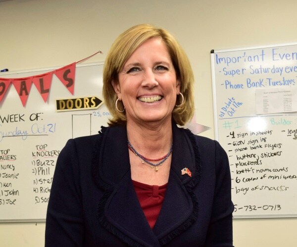 tenney in a navy blue blazer and red top