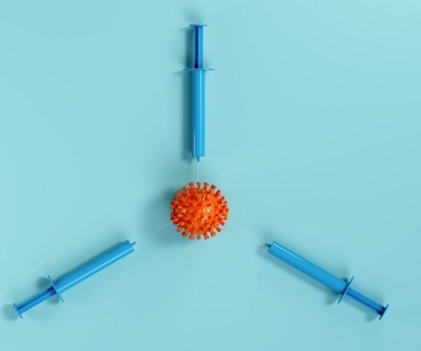 coronavirus image surrounding by three syringes pointing at it