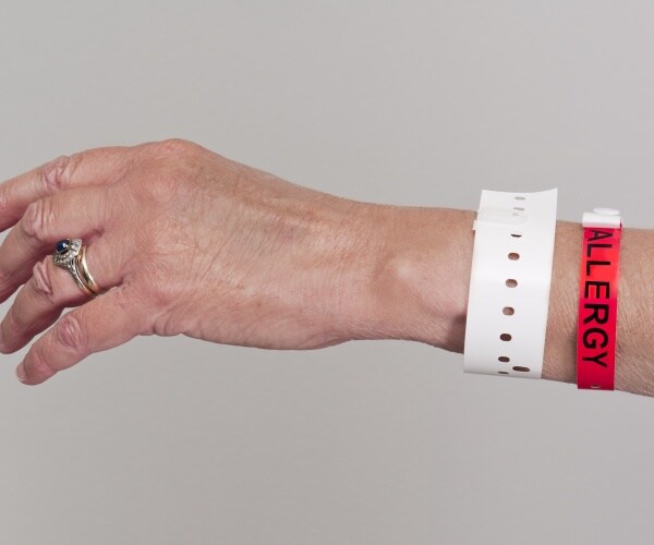 arm with hospital bracelet and allergy bracelet