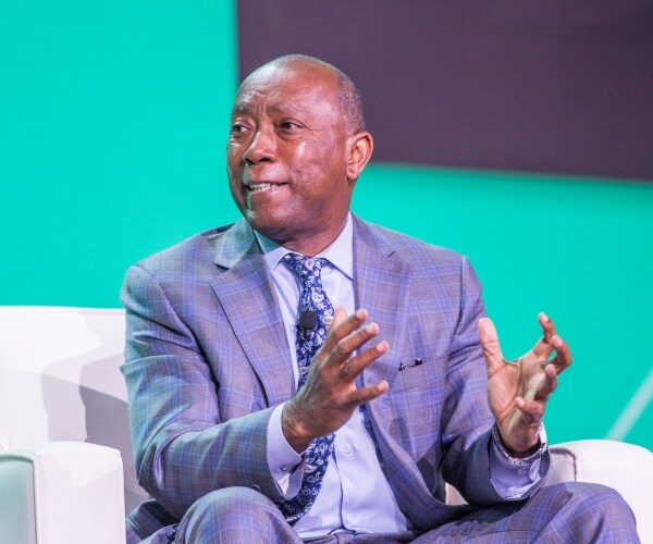 turner in a blue and black plaid suit and blue patterned tie