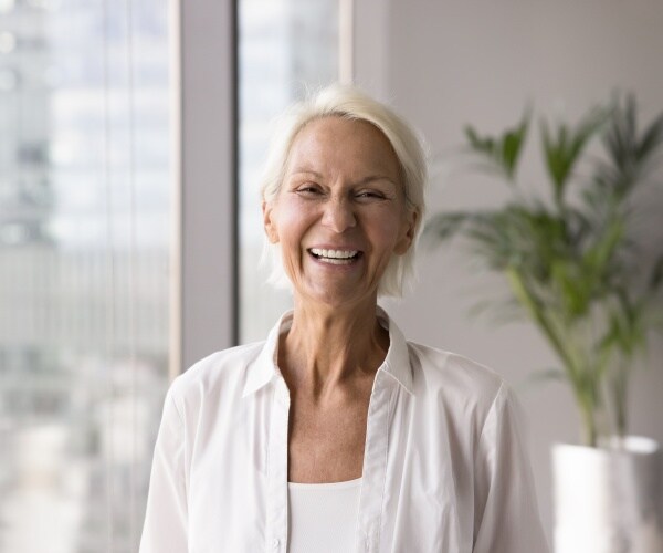 an older woman with nice teeth smiling