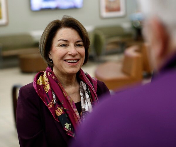 amy klobuchar speaks with a voter
