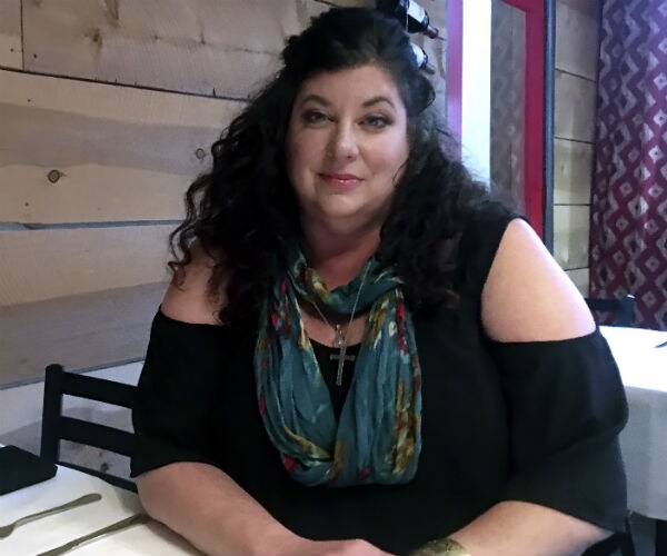 tara reade is shown in a black dress 