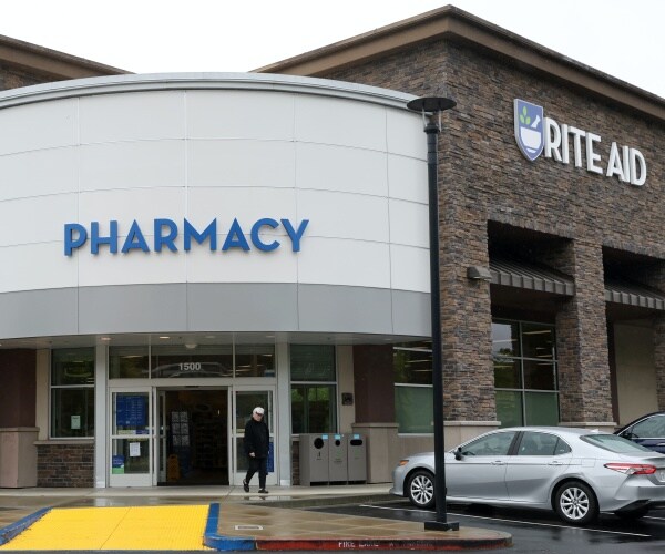 A customer leaves a Rite Aid store