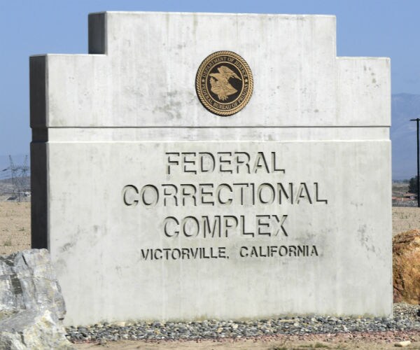 a federal prison entrance sign is shown