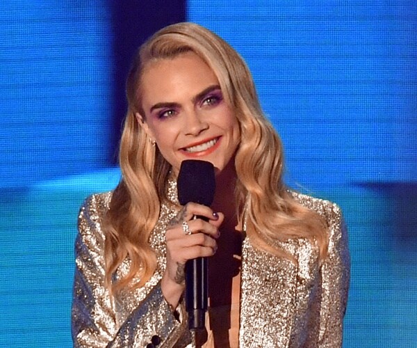 cara delevigne speaks into mic onstage