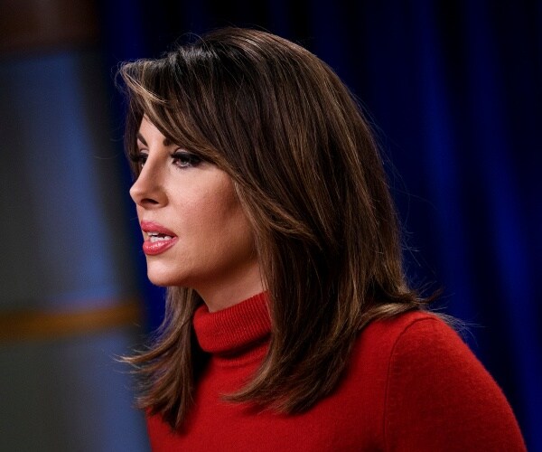 side profile view of morgan ortagus wearing a red sweater