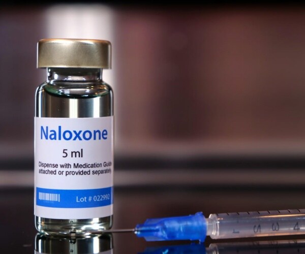 vial of naloxone and a syringe