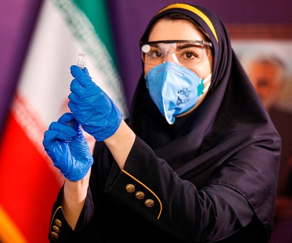 woman prepares injection