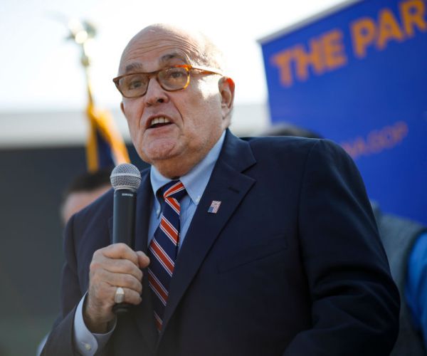 rudy giuliani speaks to the media into a mic