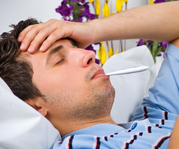 man with flu, thermometer in mouth
