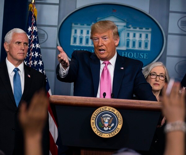 president trump gestures to a reporter answering a question
