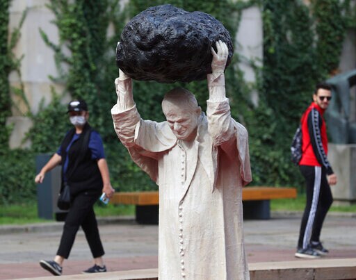 Sculpture of John Paul II with Rock, Red Water Makes Waves