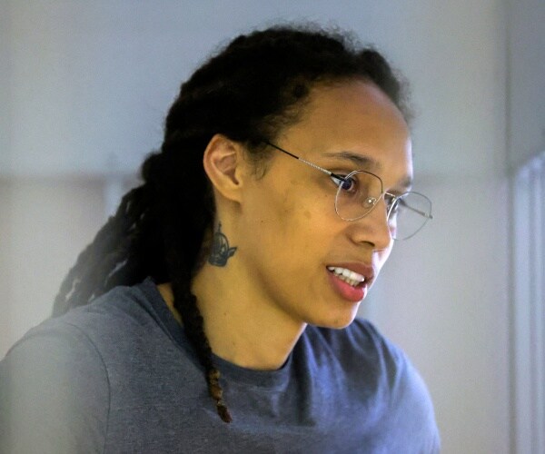 brittney griner waits inside a defendants' cage