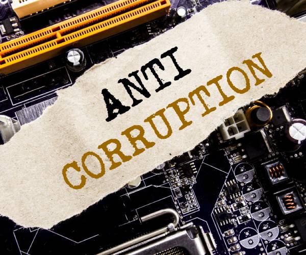 the words anti corruption over a computer circuit board