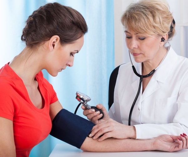 woman having her blood pressure taken