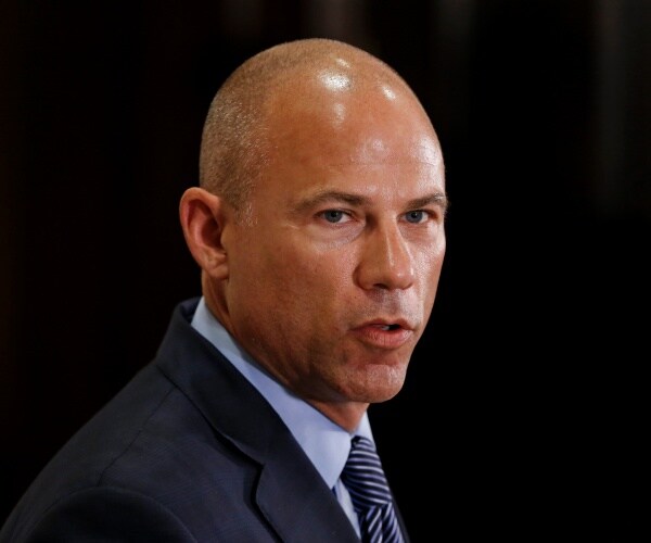 avenatti in a suit and light blue shirt and tie
