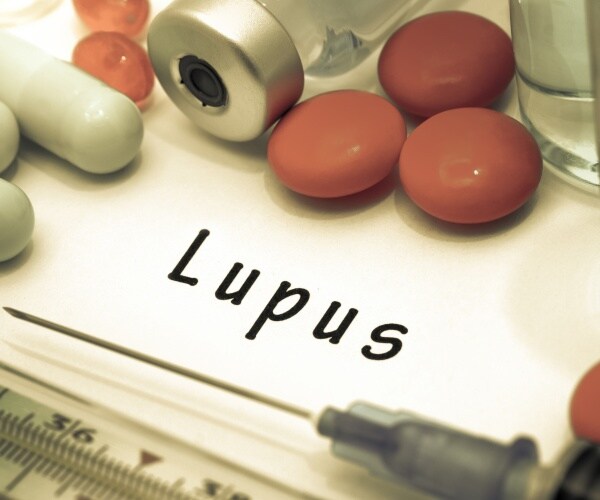The word 'lupus' surrounded by pills, syringe, treatments