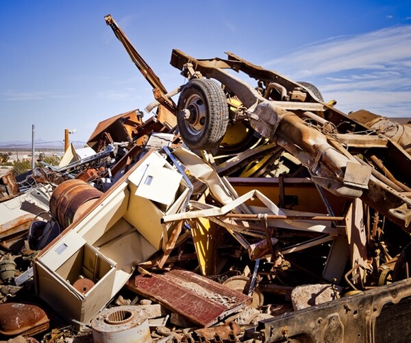 giant pile of trash and metal at a desert junk yard 