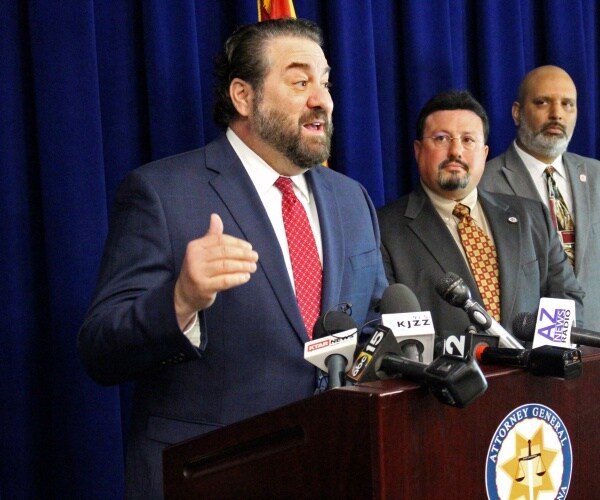 mark brnovich speaks at a podium